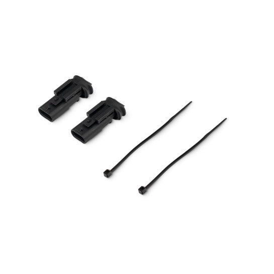 Two black plastic components and two black cables on a white background