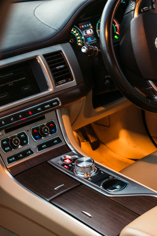 the interior of a car with a steering wheel and dashboard