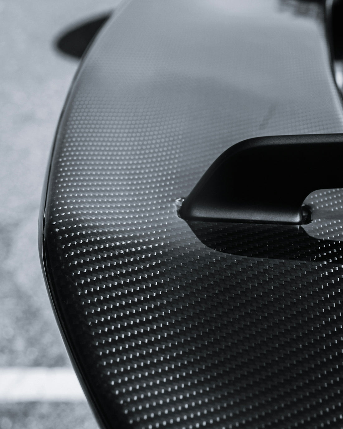 Close-up of a black carbon fiber car spoiler